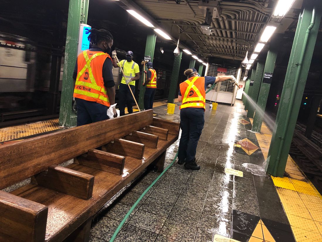 MTA workers hosing the subway platform down